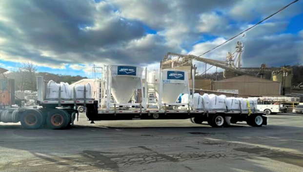 Silo Delivery by Package Pavement Truck transporting large silos for construction site